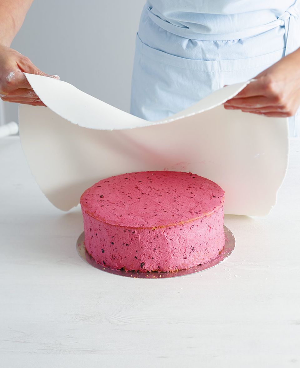 Fondant am Rand mit den Händen nach und nach glatt streichen, überstehenden Fondant abschneiden Fondant am Rand mit den Händen nach und nach glatt streichen, überstehenden Fondant abschneiden